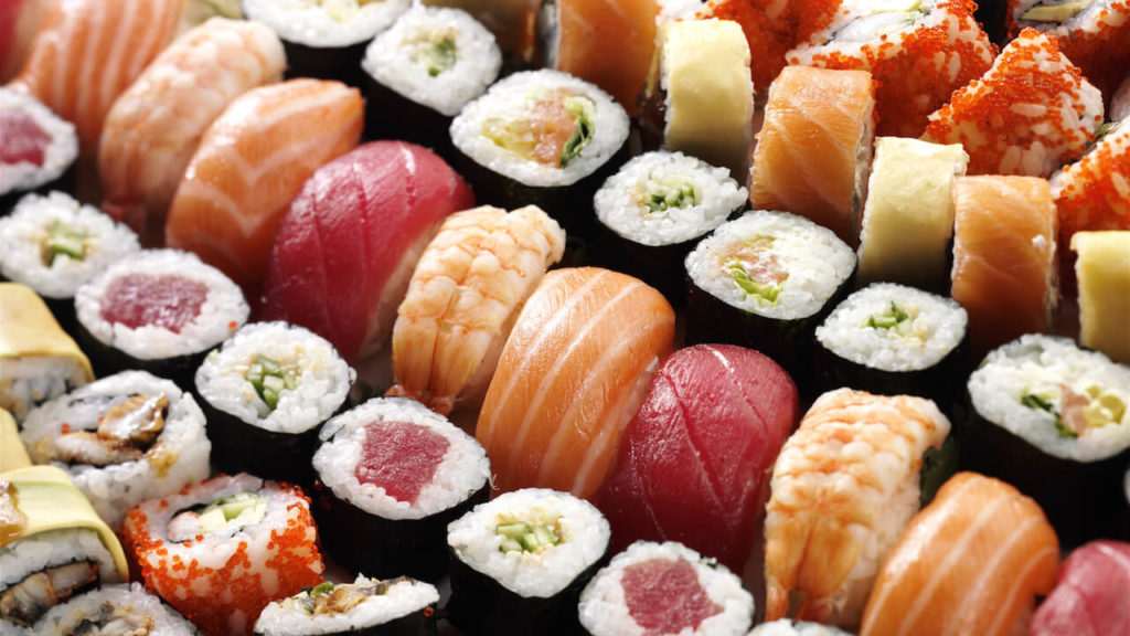 Wide range of sushi made by sushi robot machine