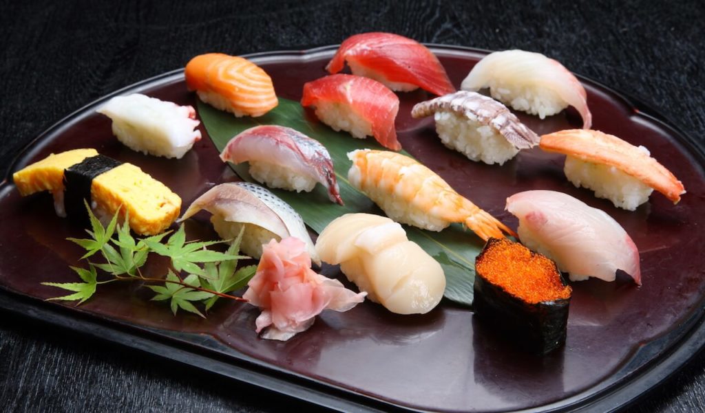 A plate of different types of nigiri sushi