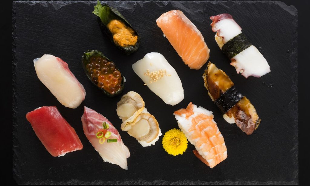 An assortment of delicious nigiri sushi with all types of different nigiri.