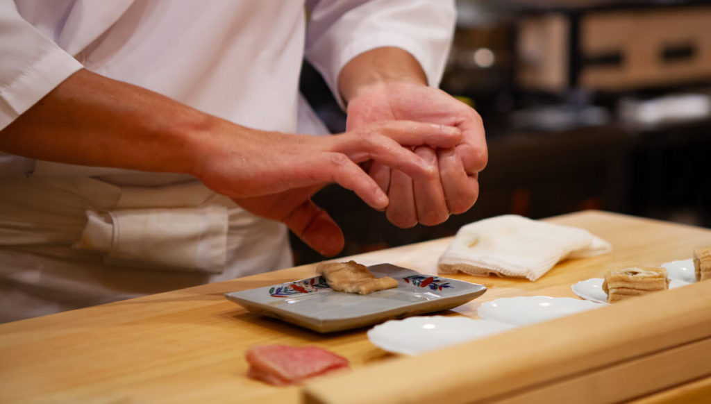 Japanese sushi chef making nigiri sushi the traditional way