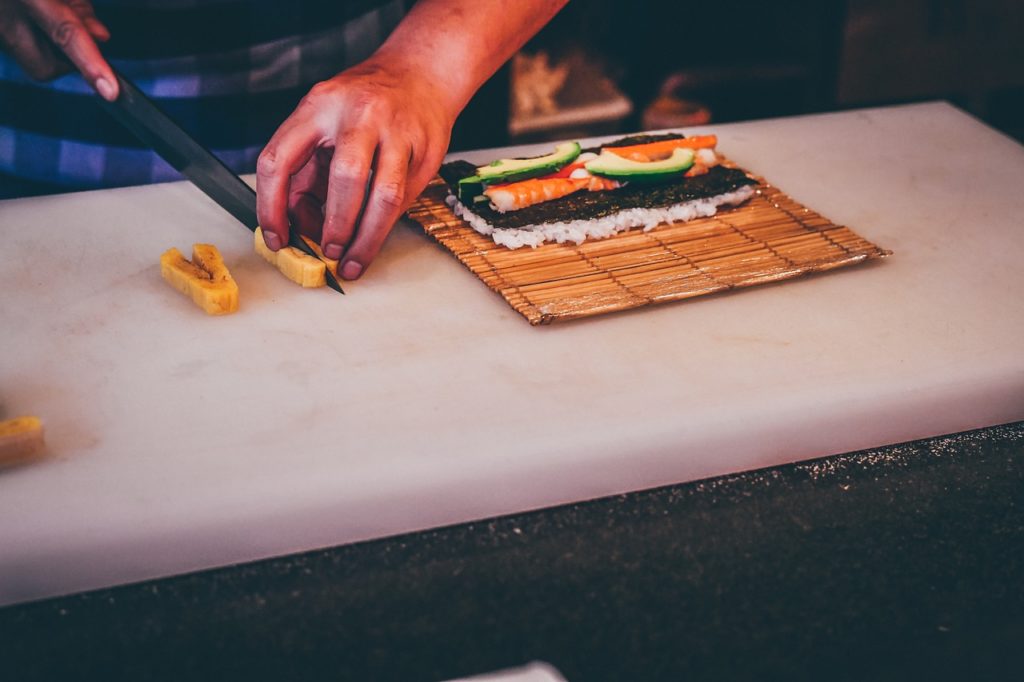 A chef preparing sushi rolls