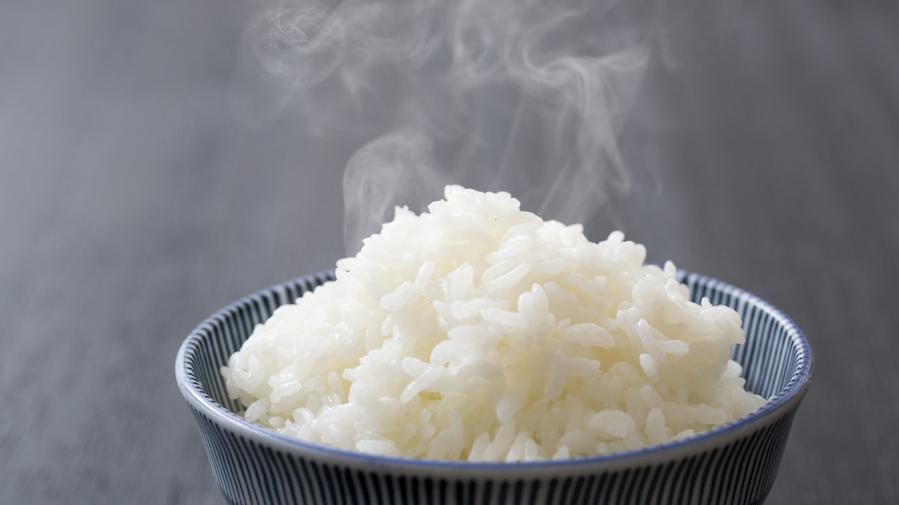 Steaming bowl of delicious rice just our of the commercial electric rice cooker